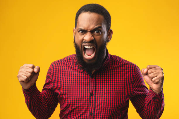 istock Angry afro man screaming with raised fists 1250202192