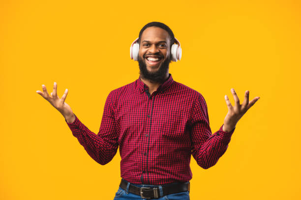 istock Smiling afro man enjoying music using headphones 1250202204