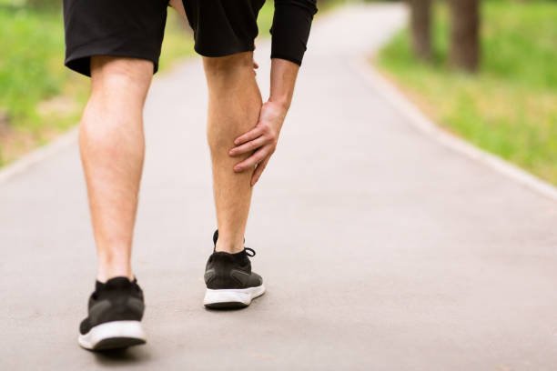 Calf sport muscle injury. Runner with muscle pain in leg Calf Injury Concept. Closeup back view of sportsman with muscle pain touching his leg, free space running jogging men human leg stock pictures, royalty-free photos & images