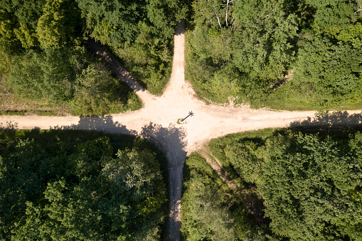 Aerial view of a crossroad in the woods.
