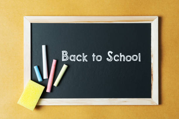 istock School supplies on black board background. Back to school concept 1250203121
