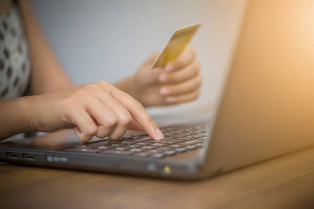 istock Female hand holding using laptop for shopping online. E-commerce concept. 1250204365