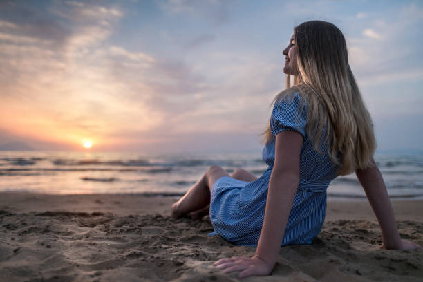 istock Relaxing on the beach at sunset. Summer vacation 1250205118