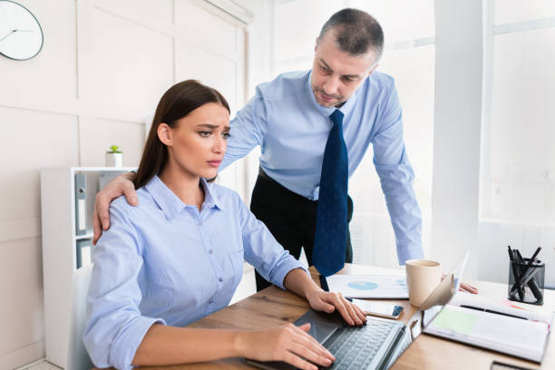 istock Sexual Harassment, Businessman Touching Woman's Shoulder Sitting In Office 1250205585