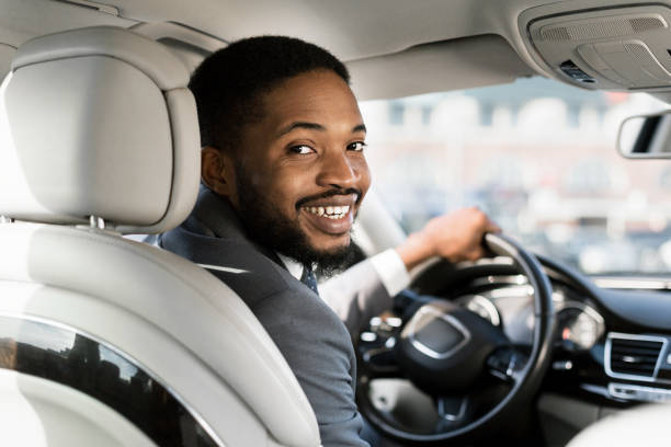 istock Smiling African Driver Looking At Camera Posing Sitting In Auto 1250206439