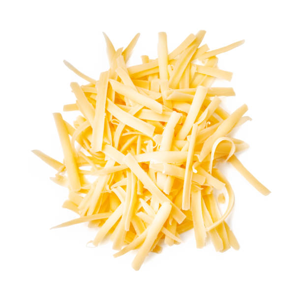 Grated cheese isolated on white background. Slices cheese. Top view. stock photo