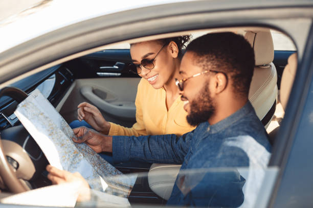 istock Spouses Looking At Map Sitting In Car Traveling On Vacation 1250208487
