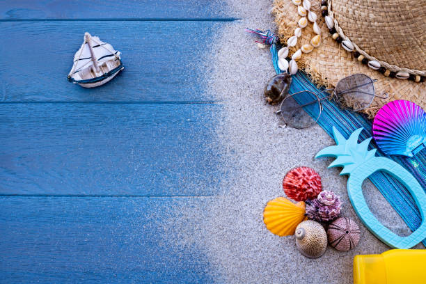 istock Beach sand and accessories with a sailing boat. 1250208514