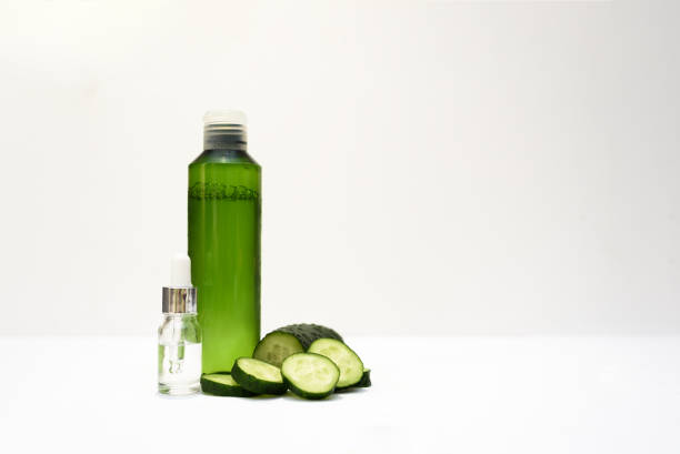 istock Cosmetic bottles and fresh cucumber on the white background. 1250208771