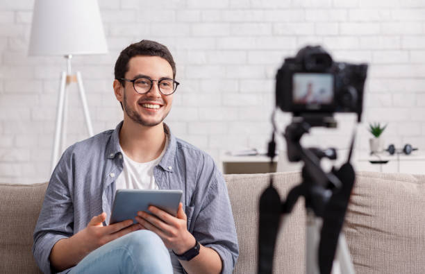 istock Personal blog and digital camera recording. Guy is filming video for work 1250209031