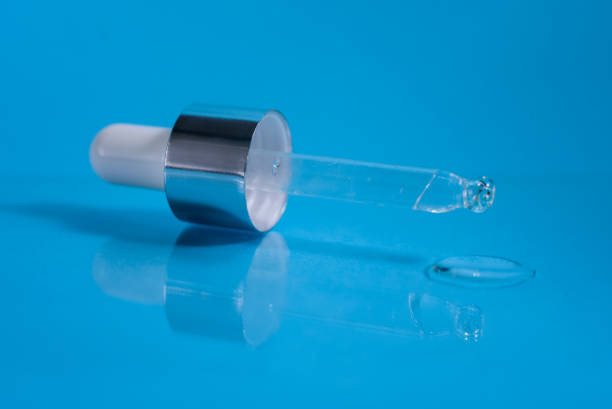 istock A pipette from serum bottle on the blue background. 1250210281