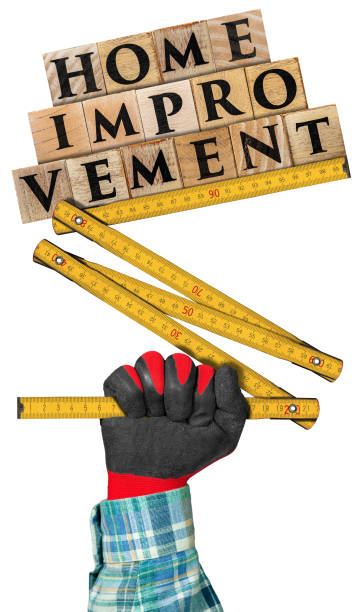 istock Hand with work glove holding a folding ruler and text Home Improvement 1250210940