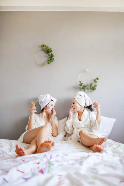 istock Girlfriends with masks on their faces drink champagne while lying in Rest is all inclusive. Hen-party. 1250212240