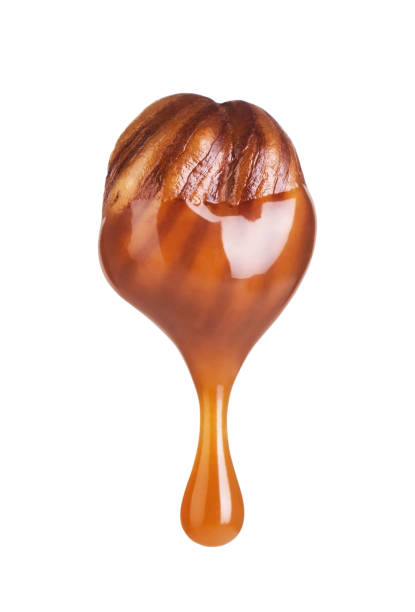 istock Hazelnut dipped in caramel  isolated on white background 1250212296