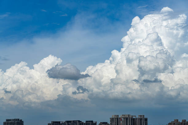 Vast white cumulus clouds with blue sky background