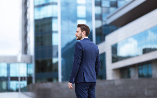 istock Confident young enterpreneur going to office building at city center 1250214726
