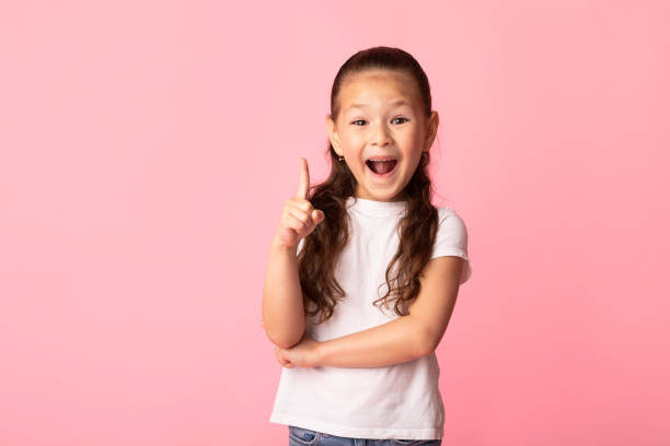 istock Excited asian girl has great idea and points up 1250216677