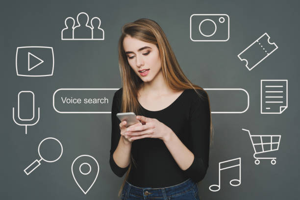 istock Girl Using Phone Voice Search App Browsing Internet, Gray Background 1250219287