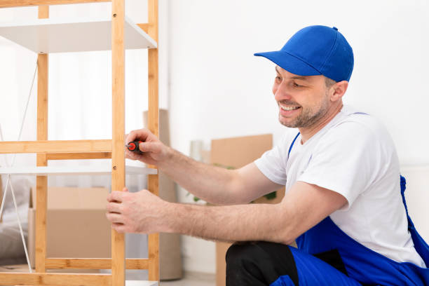 istock Happy Handyman In Blue Coverall Assembling Cabinet Using Screwdriver Indoor 1250220817