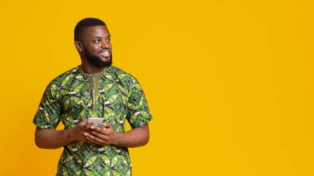 istock Happy guy with mobile phone looking at copy space 1250222580