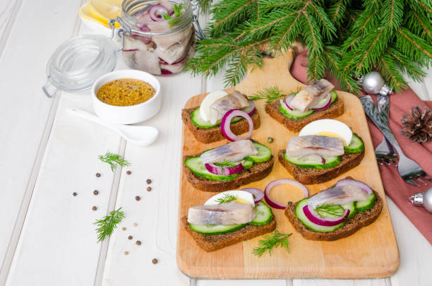 istock Open sandwich with rye bread, fresh cucumber, pickled onions, herring and dill. 1250223938