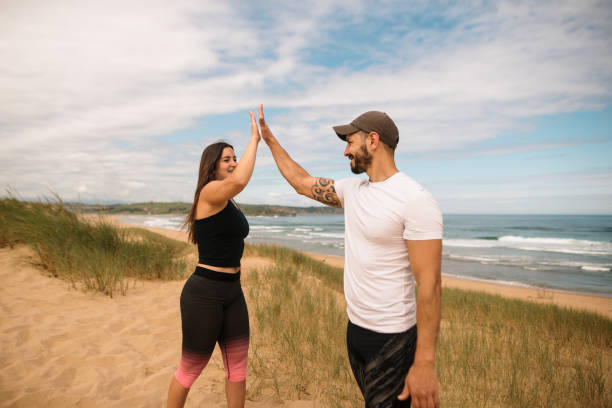 istock Satisfaction after exercising - Young couple giving a high five 1250224876