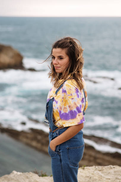istock Young woman standing by the sea 1250224905