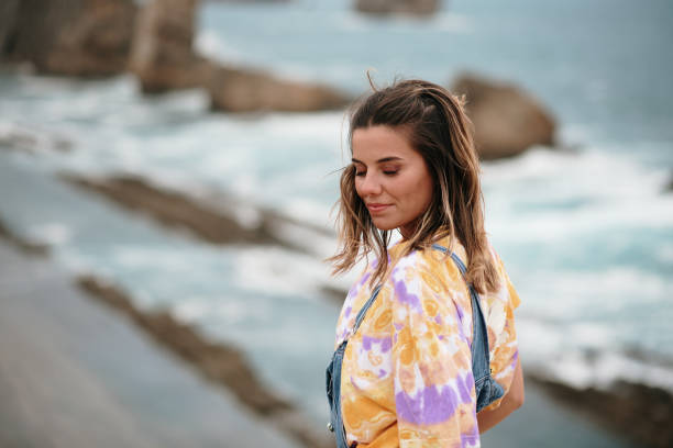 istock Young woman standing by the sea 1250224935