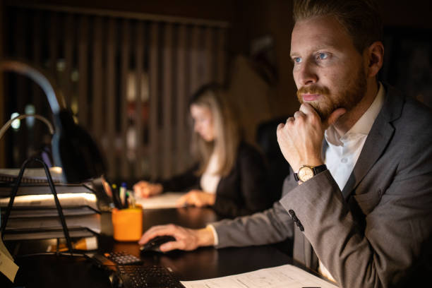 istock Dedicated business colleagues working on a project during night at office 1250227765