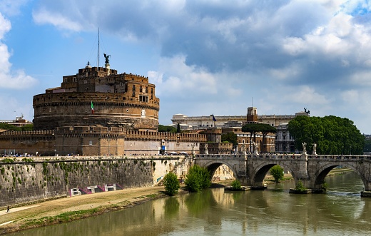 Rome, Italy, May 8, 2018: Castel Sant'Angelo and Ponte Sant'Angelo on the Tiber River. The Castel was built between 135-139. It has been demolished, repaired and rebuilt several times over the years. Originally it was built by the Roman Emperor Hadrian as a family mausoleum, later served as a papal fortress connected by a tunnel in the walls with the Vatican, residences and prisons. It currently houses a museum dedicated to the history of the building and the city of Rome.