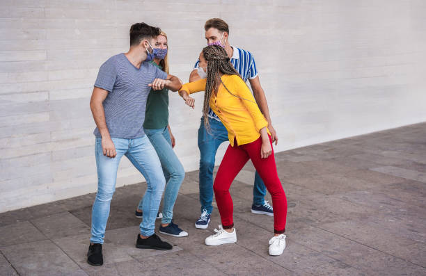 istock Young people friends bump their elbows instead of greeting with a hug - Avoid the spread of coronavirus, social distance and friendship concept - Main focus on left guy face 1250230056