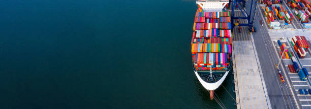 istock Container ship unloading in deep sea port, Global business logistic import export freight shipping transportation oversea worldwide container ship, Container vessel loading cargo cargo freight ship. 1250231069