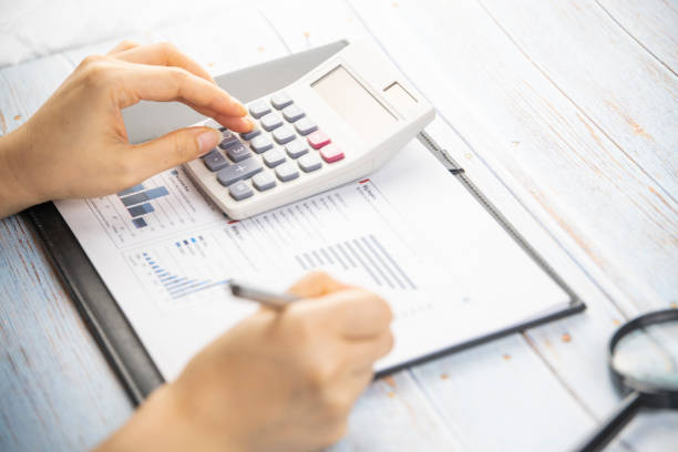 istock I'm working with a calculator and a pen in my hand 1250233751