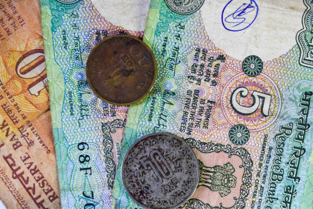 Background image of old Indian currency notes and coins.