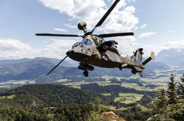 Photo of German attack helicopter flies over german landscape