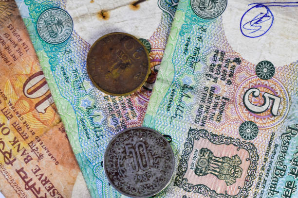 istock Background image of old Indian currency notes and coins. 1250235224
