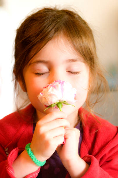 istock Girl smelling a flower 1250235343