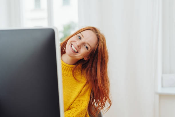 istock Cute friendly young woman peering at camera 1250235418