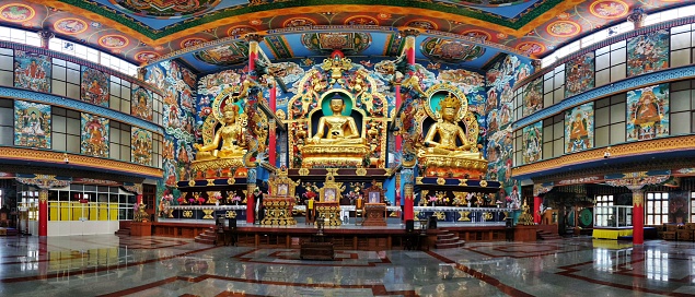 July 8, 2019 - Karnataka, India: Panorama of interior of Namdroling Monastery in Coorg district, Karnataka, India. It is also known as Golden Temple and is a Buddhist monastery. Statue of Buddha.