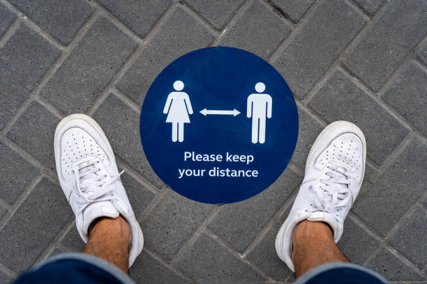 istock Covid-19 social distancing notice disk on ground 1250240848