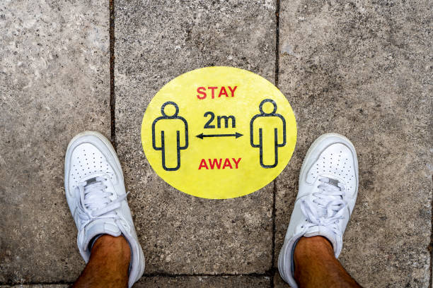 istock Covid-19 social distancing notice disk on ground 1250241146