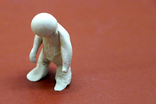 a figure of a drooping man, symbolizing a crisis, fatigue, collapse.