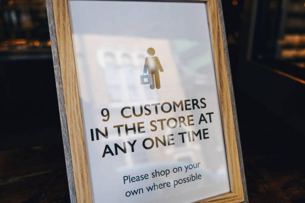 istock Shop customer number limitation sign during COVID-19 1250242044