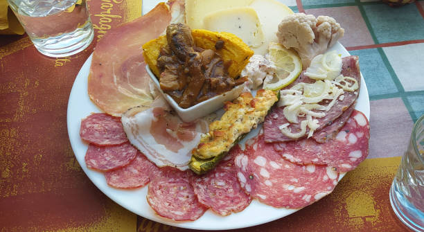 istock rustic Tuscan tray with typical products, sliced cheese and various cold cuts for dinner 1250242123