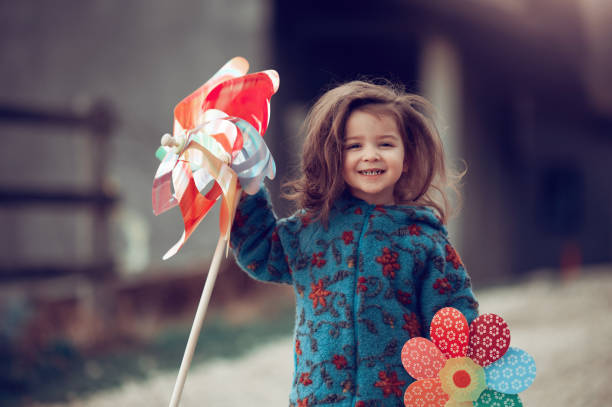 istock Happy and laughing while playing with my pinwheel 1250242665