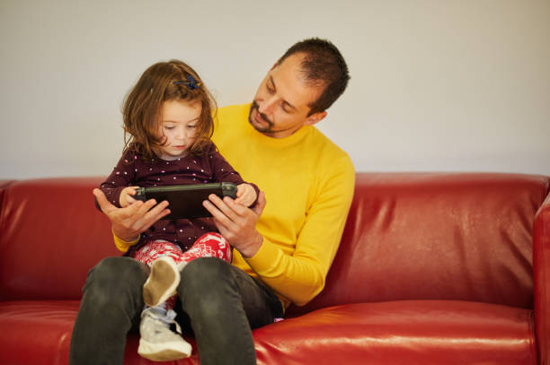 istock Father showing baby girl technological device 1250242682