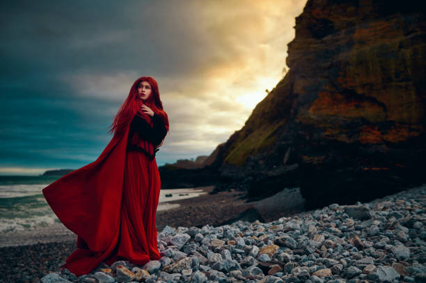 istock Posing in red cape on the coastline 1250242793