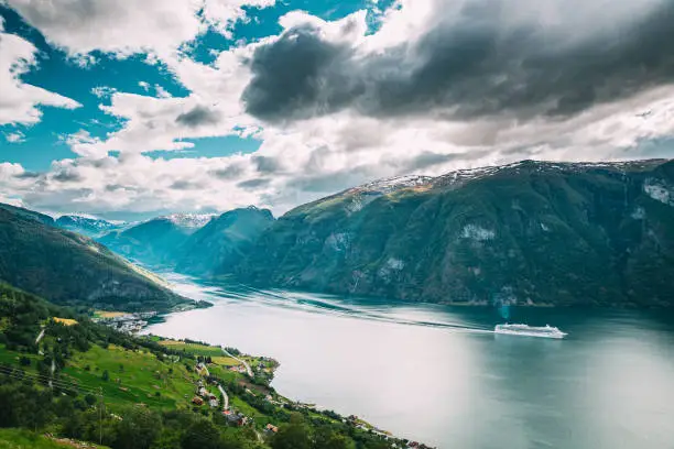 Photo of Aurland, Sogn And Fjordane Fjord, Norway. Amazing Summer Scenic View Of Sogn Og Fjordane. Ship Or Ferry Boat Liner Floating In Famous Norwegian Natural Landmark And Popular Destination In Summer Day