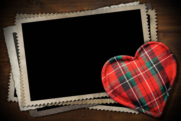 istock Stack of old vintage photo frames and a fabric heart shape 1250243996