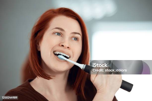Loving The Morning Routine Stock Photo - Download Image Now - Electric Toothbrush, Brushing Teeth, Females